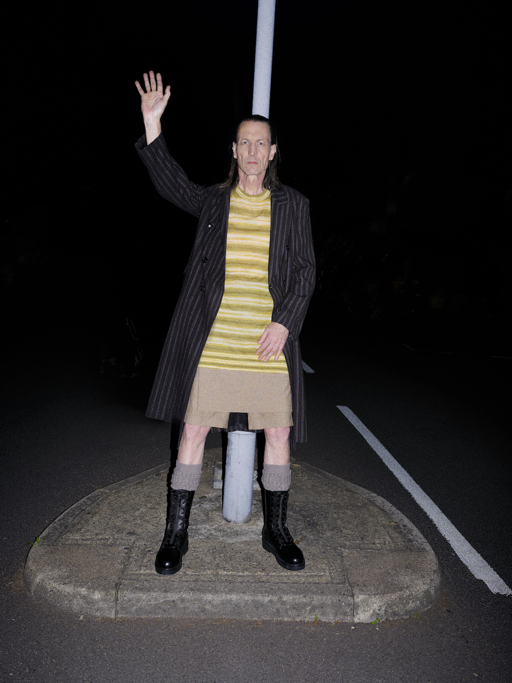 Coat by OUR LEGACY, top and short by DRIES VAN NOTEN, socks by RICK OWENS, boots by VALENTINO