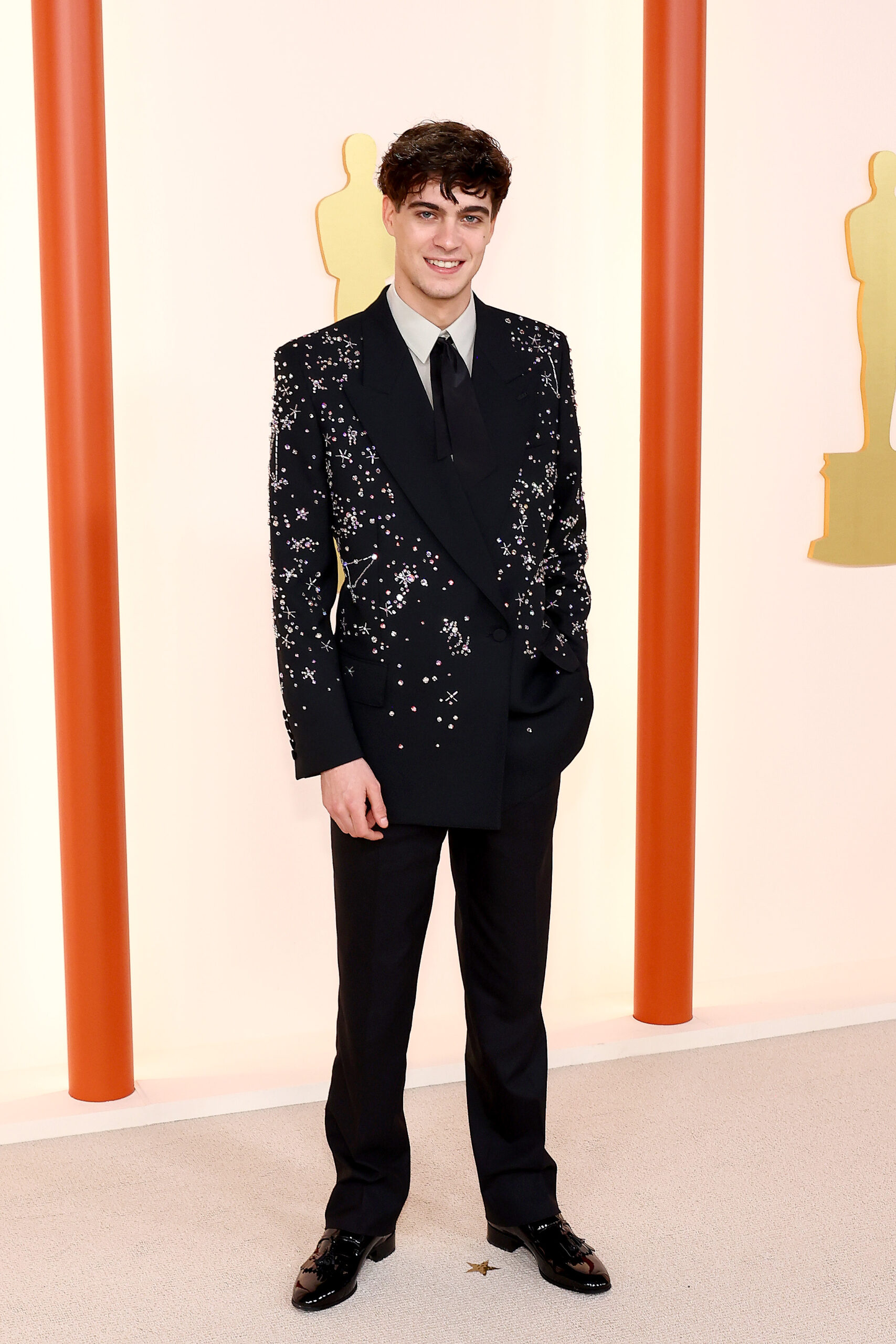 Lorenzo Zurzolo wore a custom Gucci black crystal-embroidered tuxedo, beige evening shirt, black tie, and black leather lace-ups.