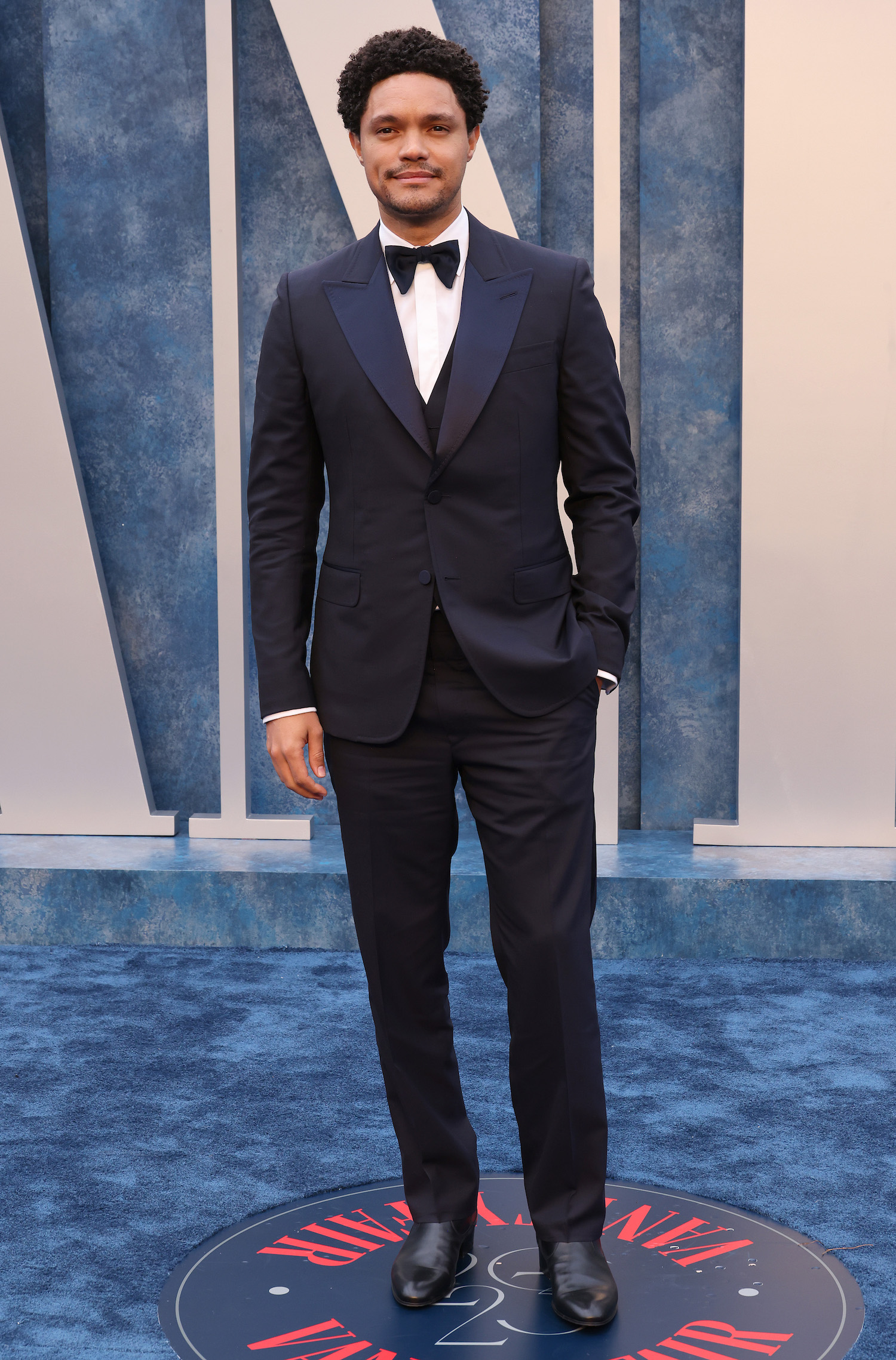 Trevor Noah wore a navy Gucci three-piece tuxedo, white evening shirt, black bowtie, and black leather boots.