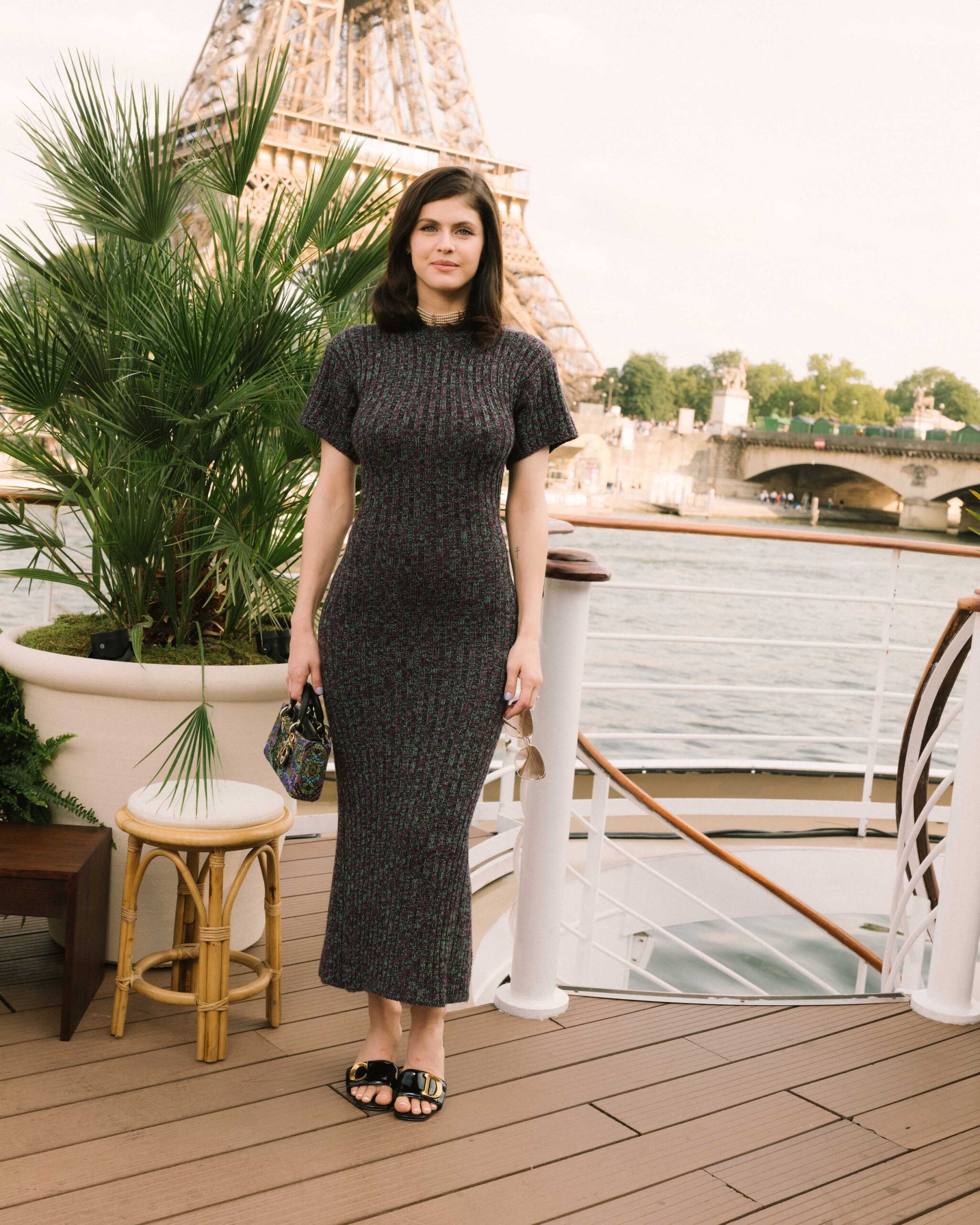 Alexandra Daddario in Dior Pre Fall 2023 Alexandra Daddario showcased impeccable style in a purple knit dress from the Dior Pre Fall 2023 collection. She completed her look with a Dior bag, necklace, and shoes.