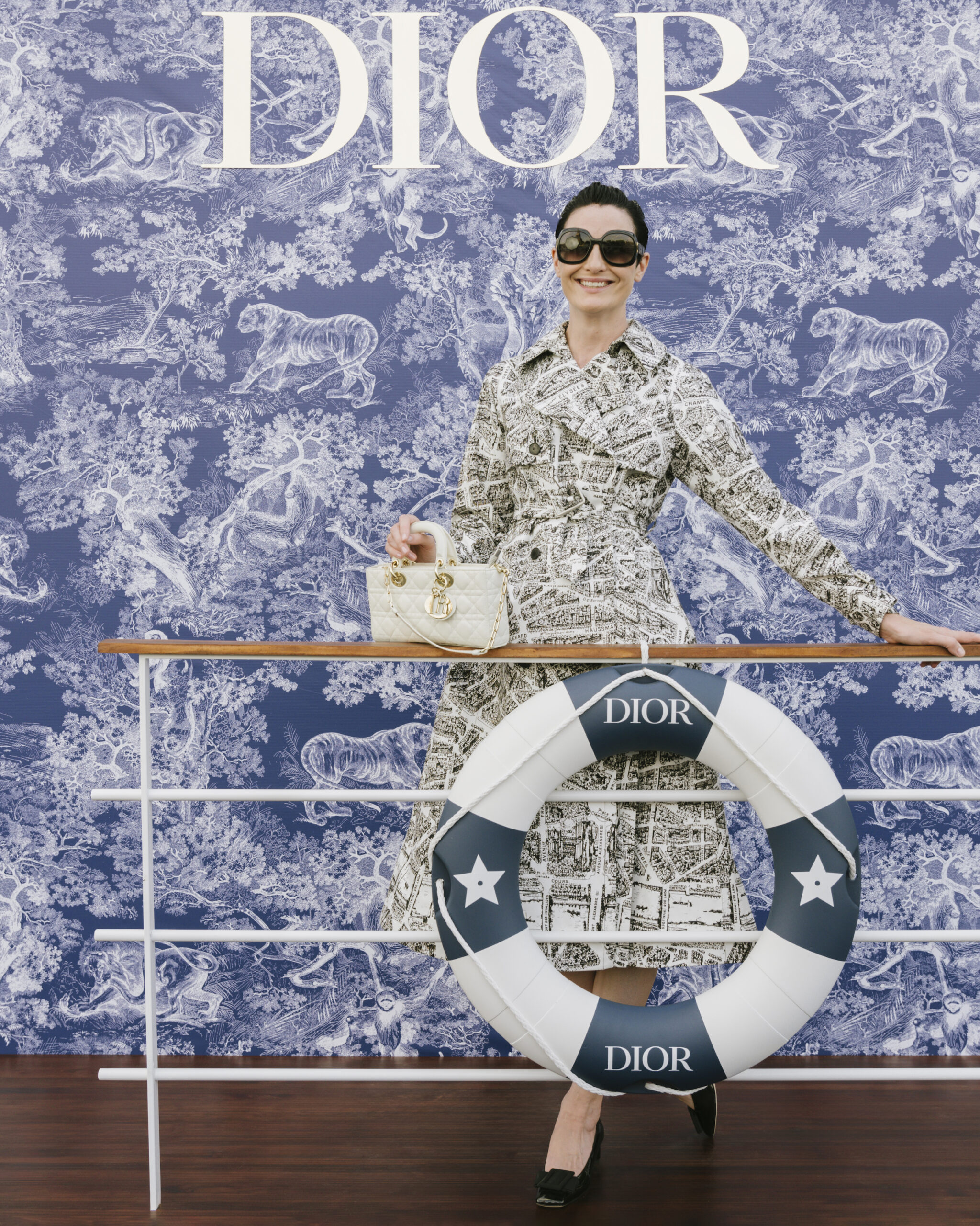 Erin O'Connor in Dior Spring-Summer 2023 Erin O'Connor showcased sophistication in a printed cotton trench-coat from the Dior Spring-Summer 2023 collection. She accessorized with a Dior bag and sunglasses.
