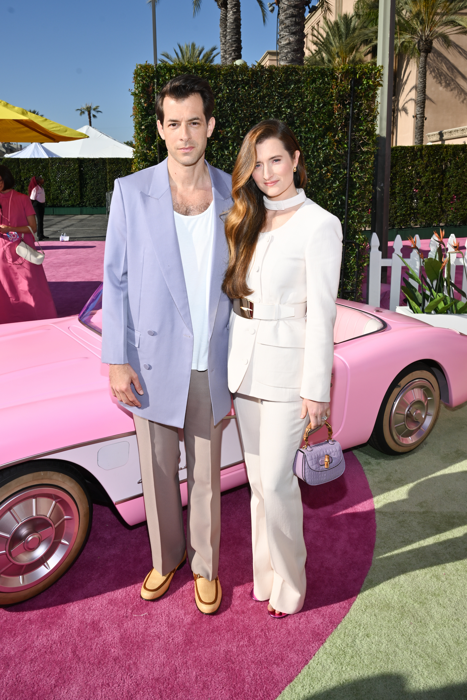 MARK RONSON wore a GUCCI Fall/winter 2023 jacket, pants and t-shirt and loafers with Horsebit detail. GRACE GUMMER wore a GUCCI jacket, pants and belt and a Gucci Bamboo 1947 handbag.
