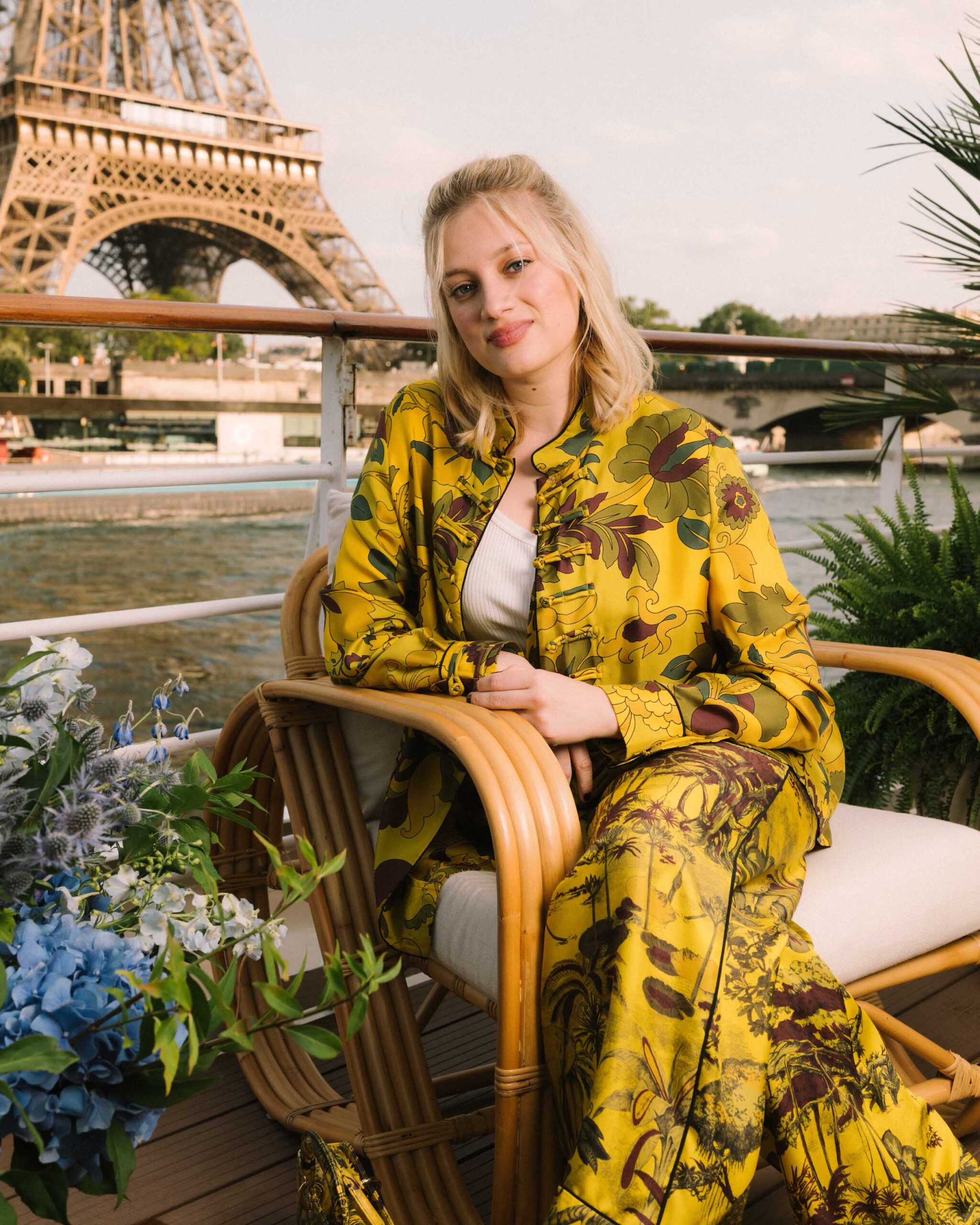 Nadia Tereszkiewicz in Dior Pre Fall 2023 Nadia Tereszkiewicz opted for a bold and playful look, wearing a printed yellow silk shirt and pants from the Dior Pre Fall 2023 collection. She paired it with a white cotton top.