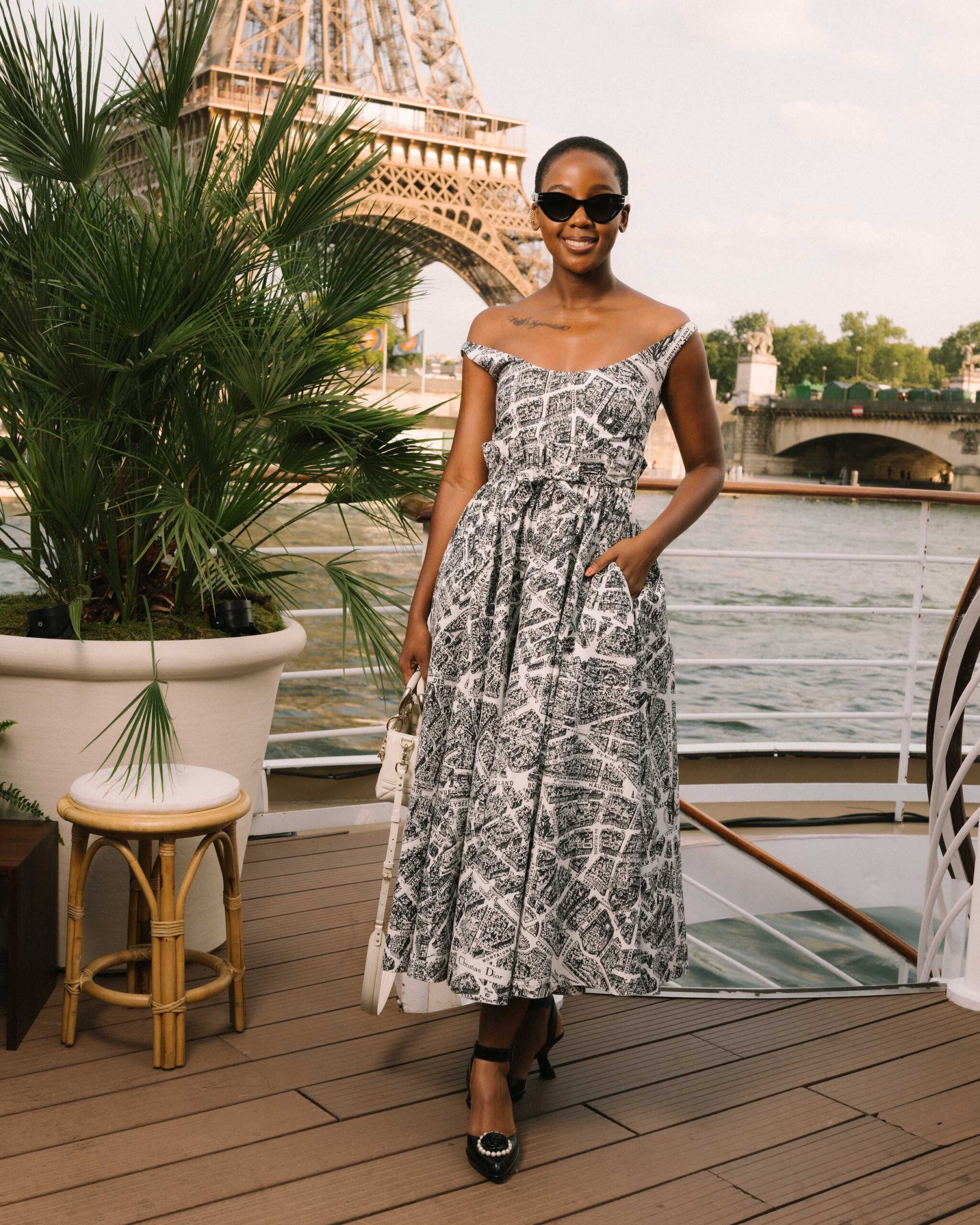 Thuso Mbedu in Dior Spring-Summer 2023 Thuso Mbedu made a statement in a printed white and black cotton dress from the Dior Spring-Summer 2023 collection. She accessorized with a Dior bag, sunglasses, and shoes.