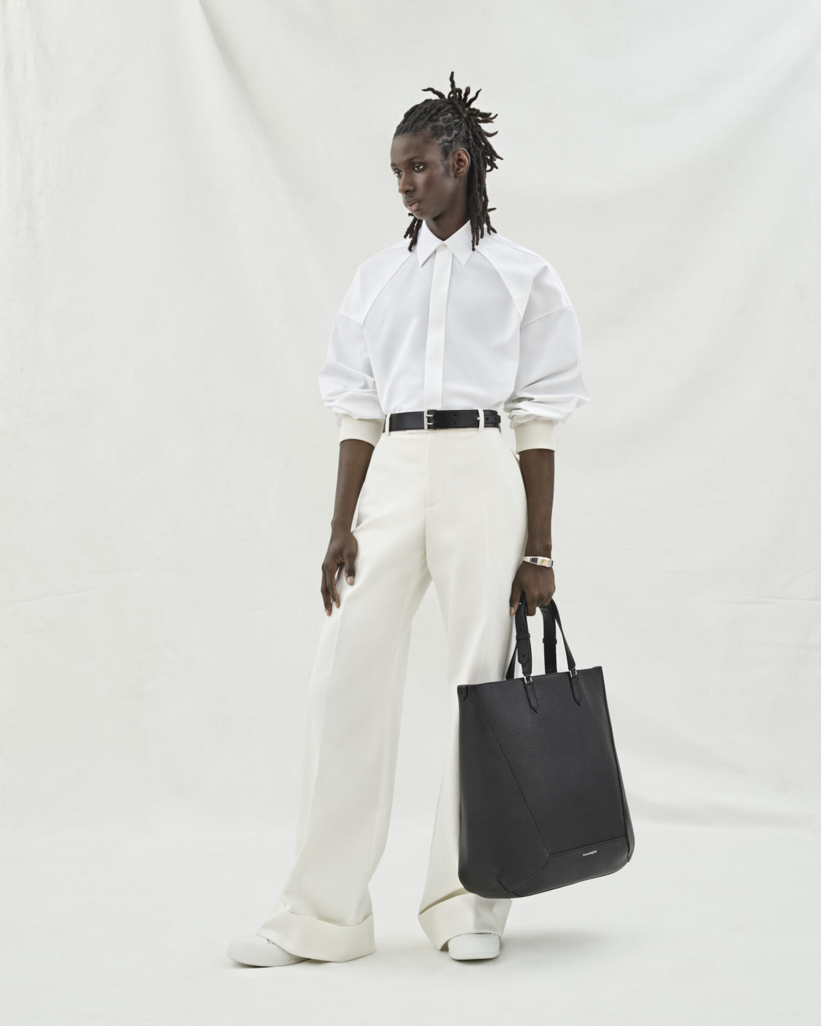 Look 06: White cotton poplin shirt with dropped harness shoulders, paired with wide-legged trousers