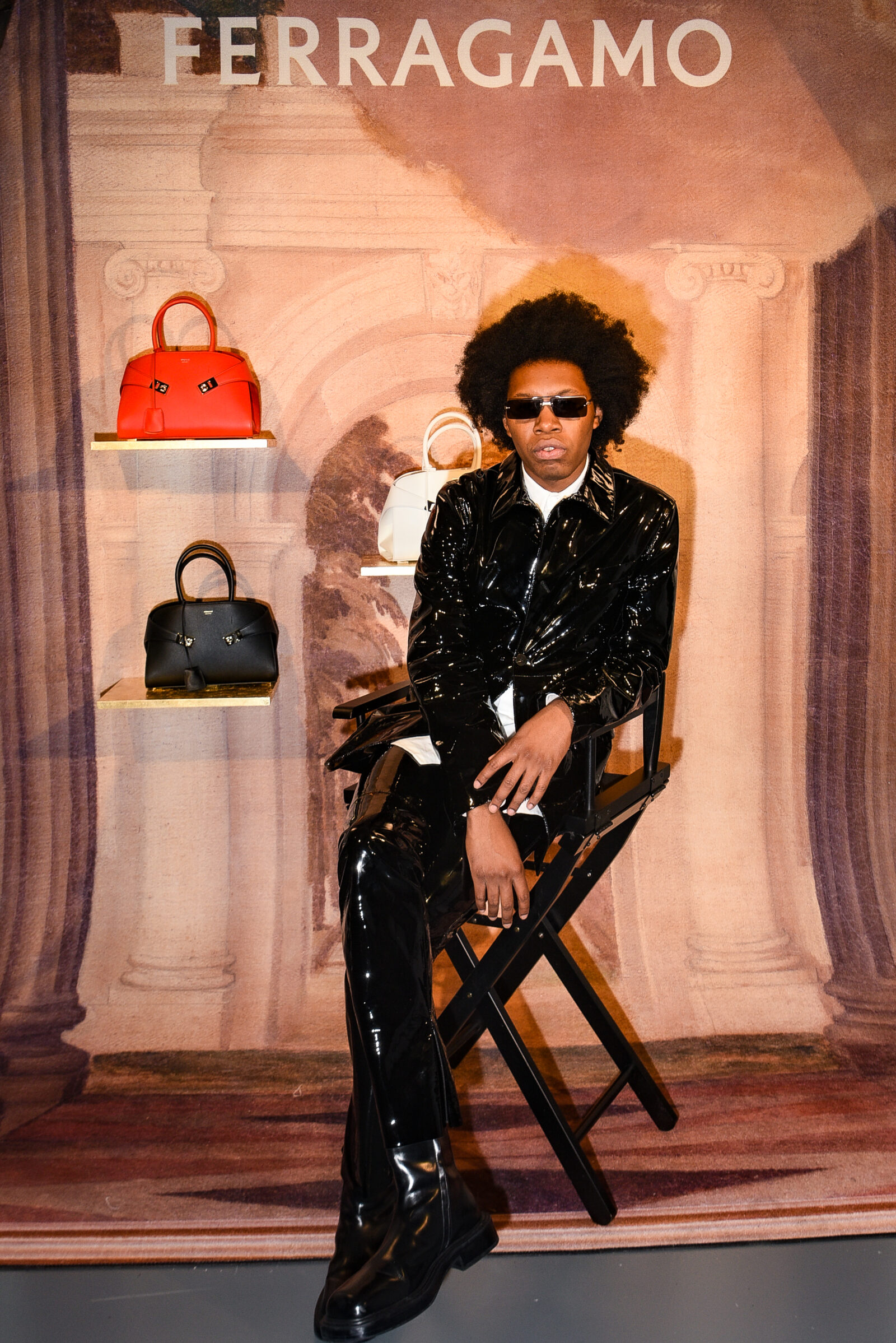 Jeremy O'Harris exuding style and confidence at the Ferragamo Fall-Winter 2023 event, surrounded by the brand's latest handbag creations.