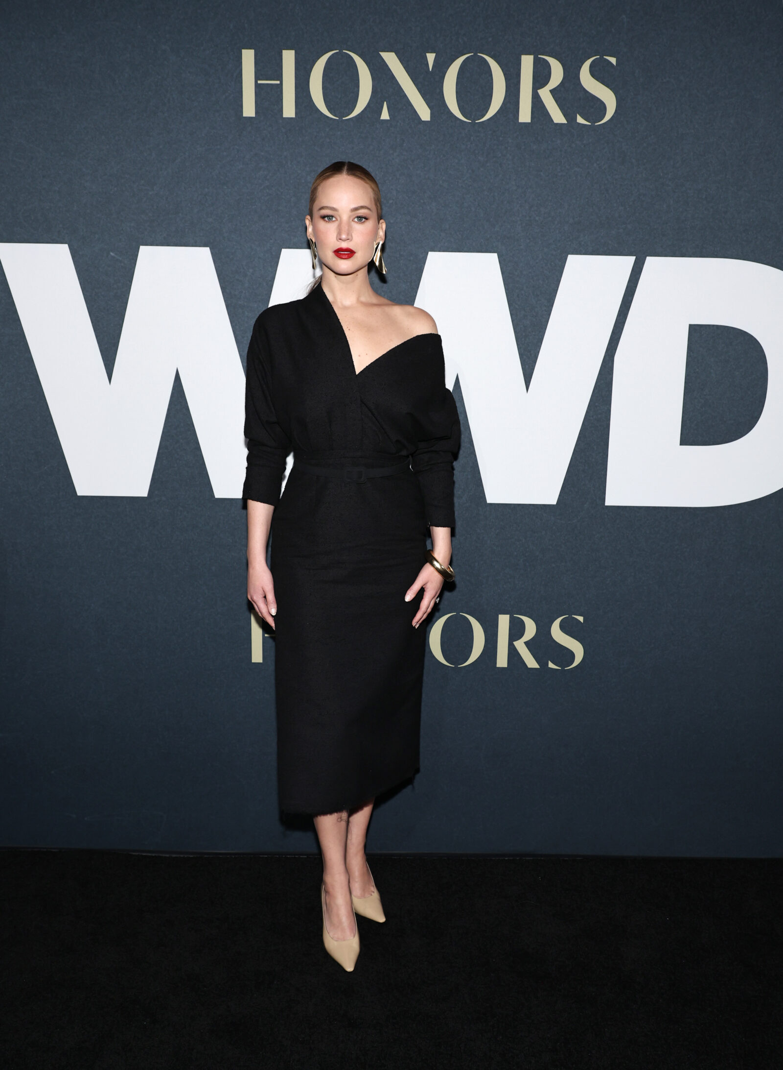 Jennifer Lawrence exudes sophistication in a sleek black Dior ensemble at the WWD Honors event.