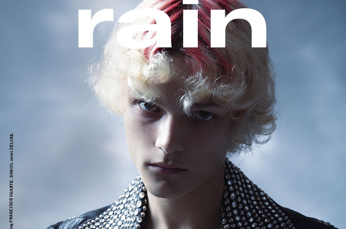 Cover of Rain Magazine featuring a model in a studded Celine Homme leather jacket with a red streak in his blonde hair, embodying the theme of 'Renaissance'.