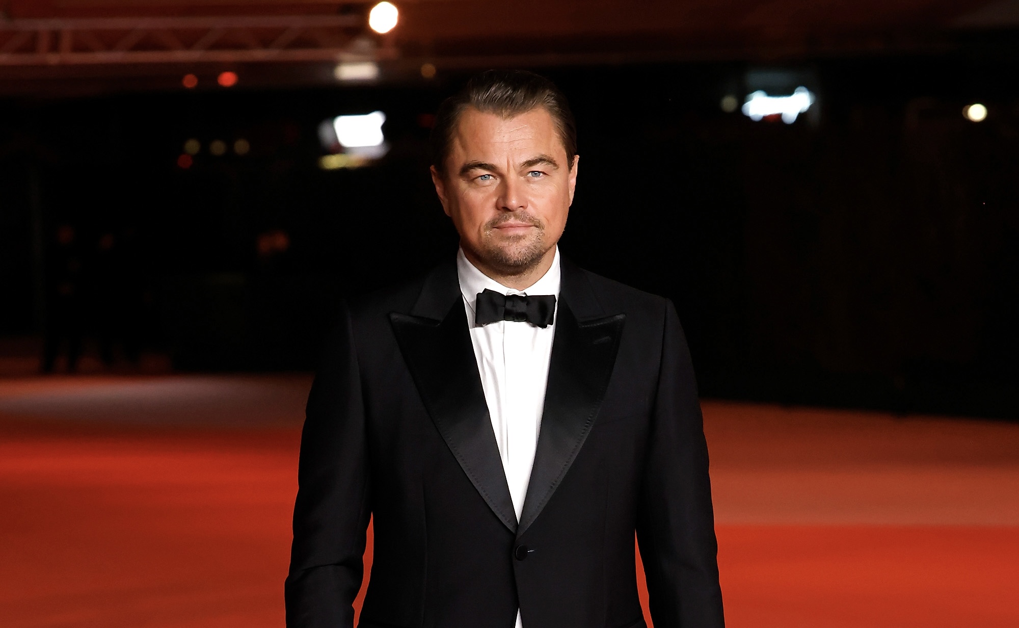Leonardo DiCaprio in a classic tuxedo at the Academy Museum Gala in Los Angeles, exemplifying traditional Hollywood elegance.