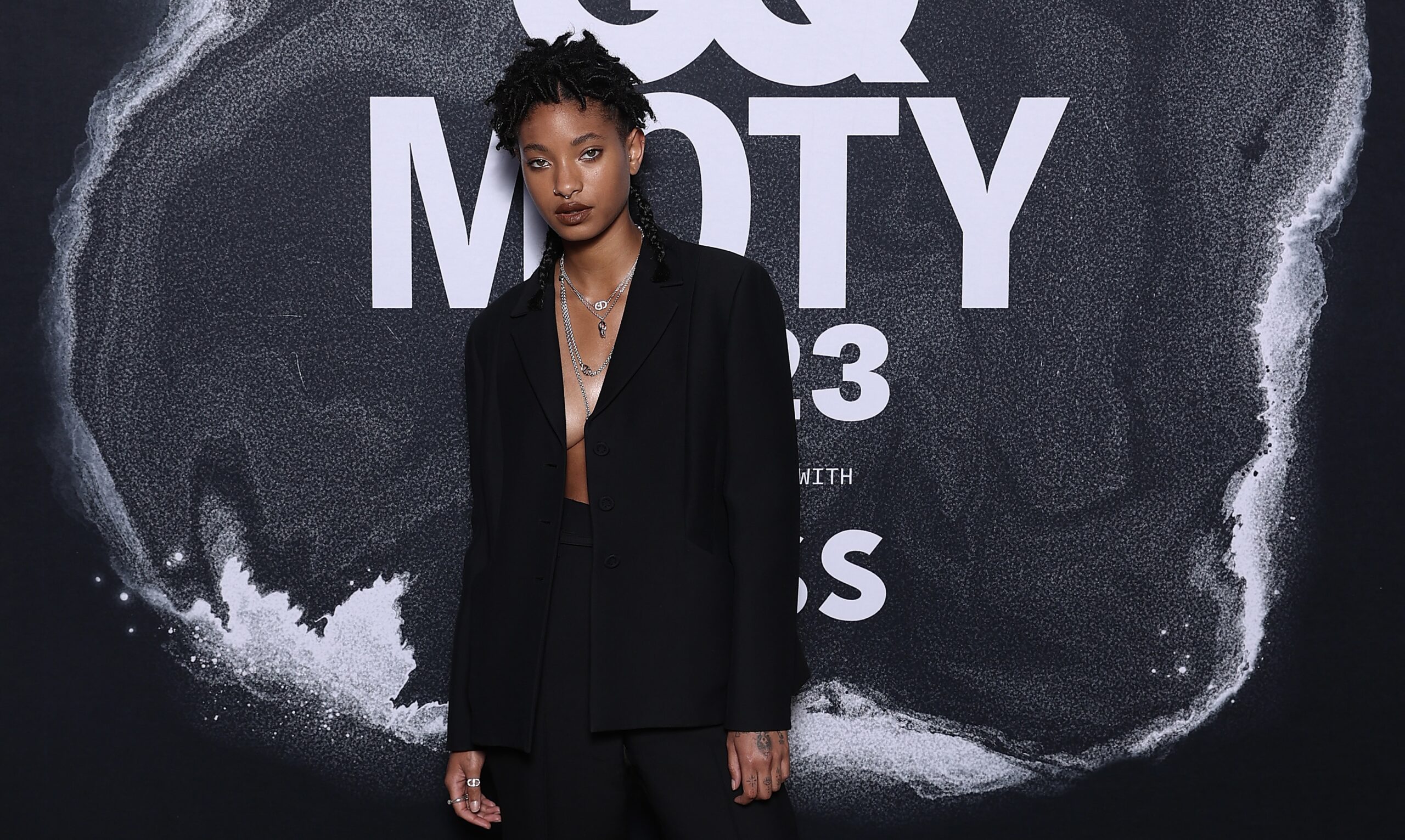 Willow Smith at the GQ Australia Men Of The Year Awards in a tailored black suit, exemplifying androgynous style on the red carpet in Sydney, Australia.