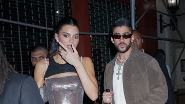 Kendall Jenner in a silver mini dress and Bad Bunny in a taupe jacket seen together in New York City, heading to a Met Gala afterparty.