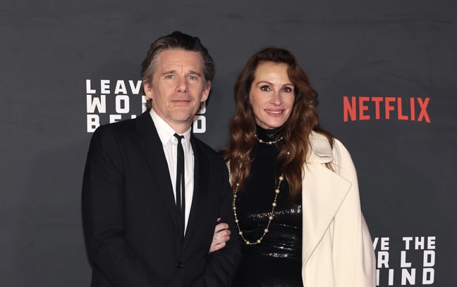 Ethan Hawke at the 'Leave the World Behind' premiere, dressed in a pinstripe CELINE HOMME suit, exuding modern sophistication.