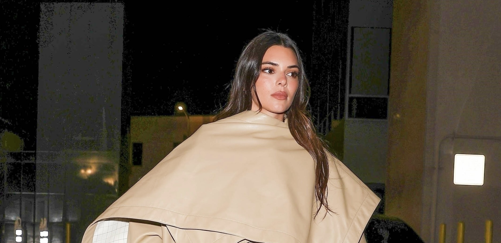 Supermodel Kendall Jenner leaving Wally’s Restaurant in Beverly Hills, wearing a Bottega Veneta leather trench coat, exuding high fashion and sophistication.