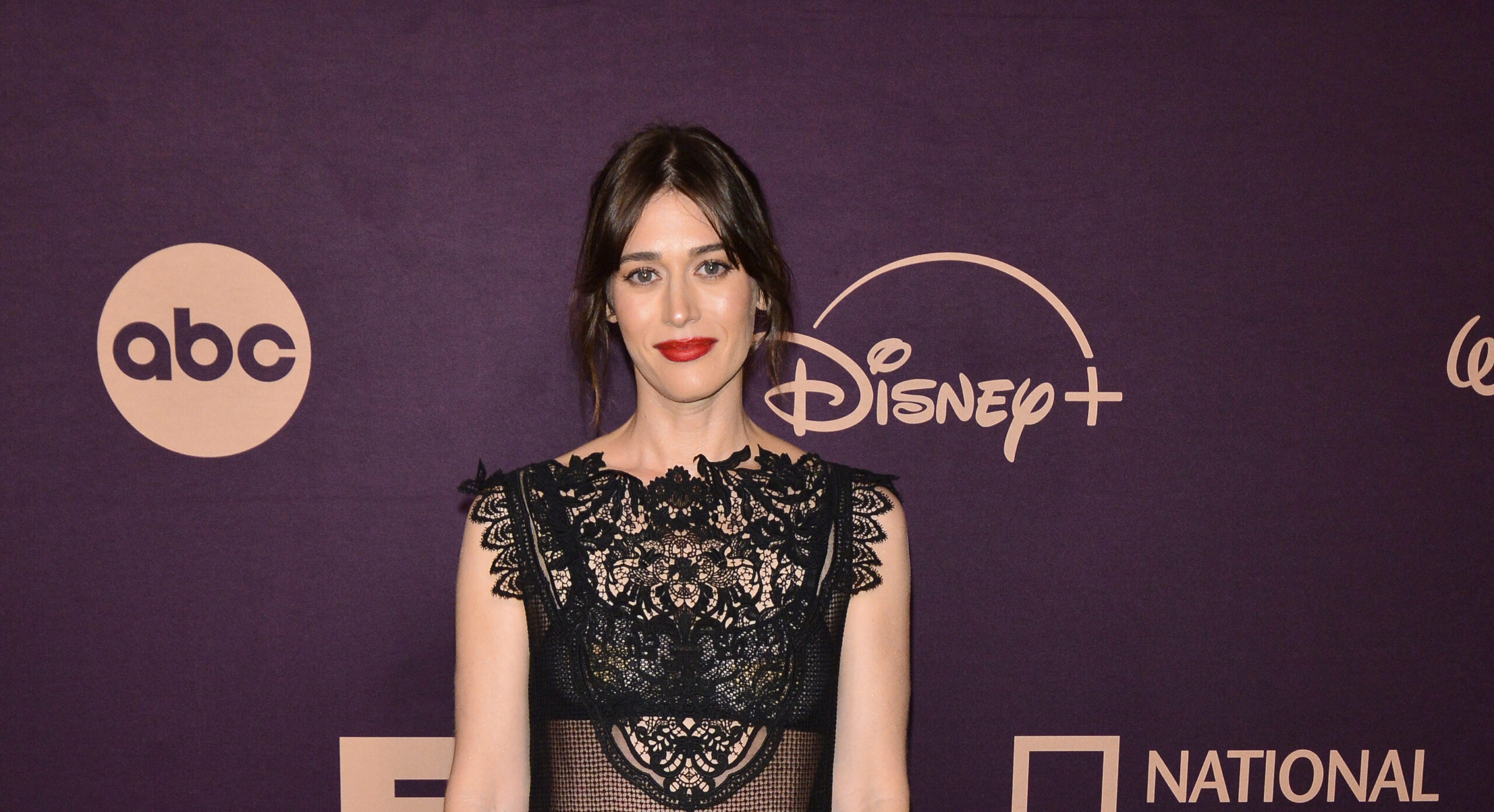 Lizzy Caplan at Disney's Emmy Awards Party in a Dior black lace gown.