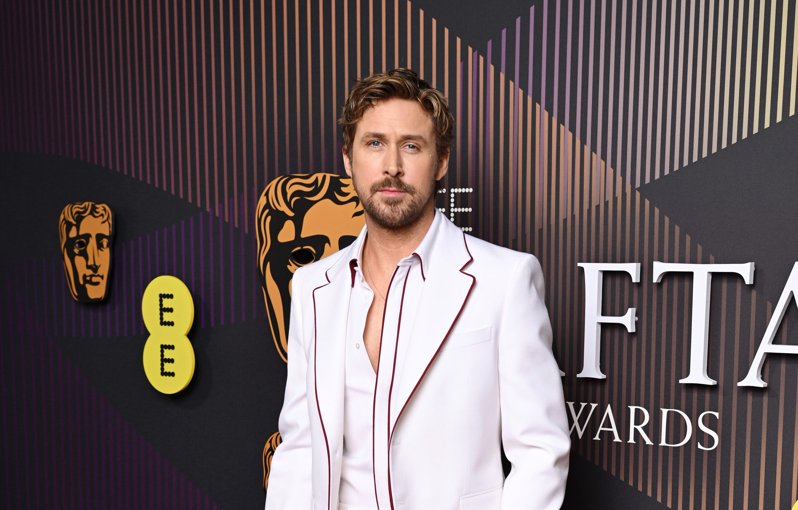 Ryan Gosling makes an elegant statement at the 2024 EE BAFTA Film Awards in a custom white Gucci suit with Rosso Ancora piping.