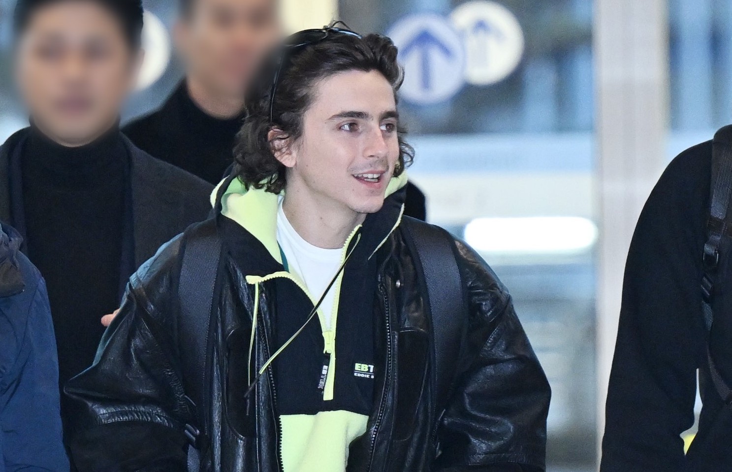Timothée Chalamet walks through Incheon Airport, dressed in casual yet stylish attire, featuring a pair of Gucci Re-Web sneakers.