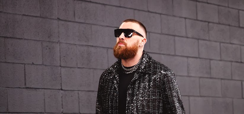 Travis Kelce makes a bold fashion statement in a sequin-embellished bouclé suit from AMIRI.