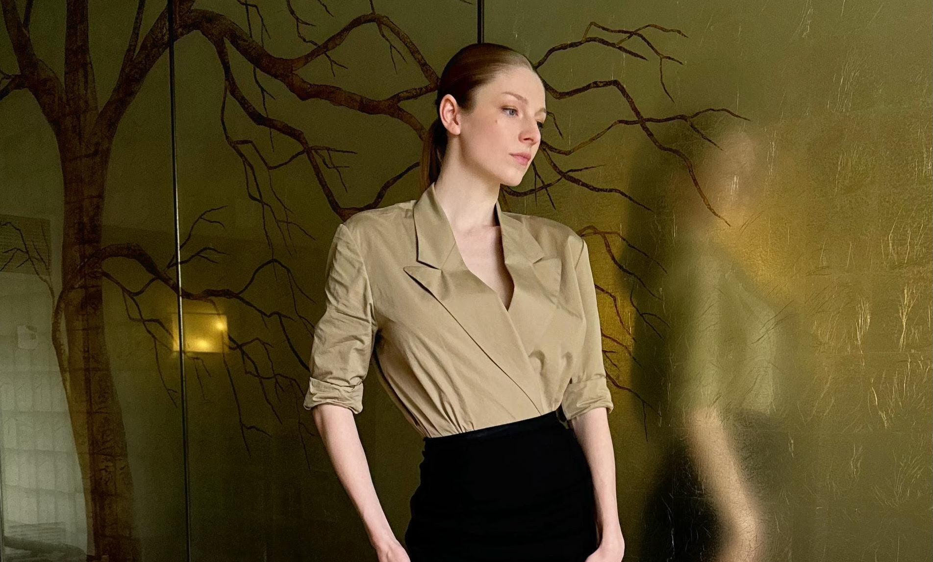 Hunter Schafer strikes a contemplative pose in a Dries Van Noten outfit at SXSW, reflecting her "Cuckoo" character's layered persona.