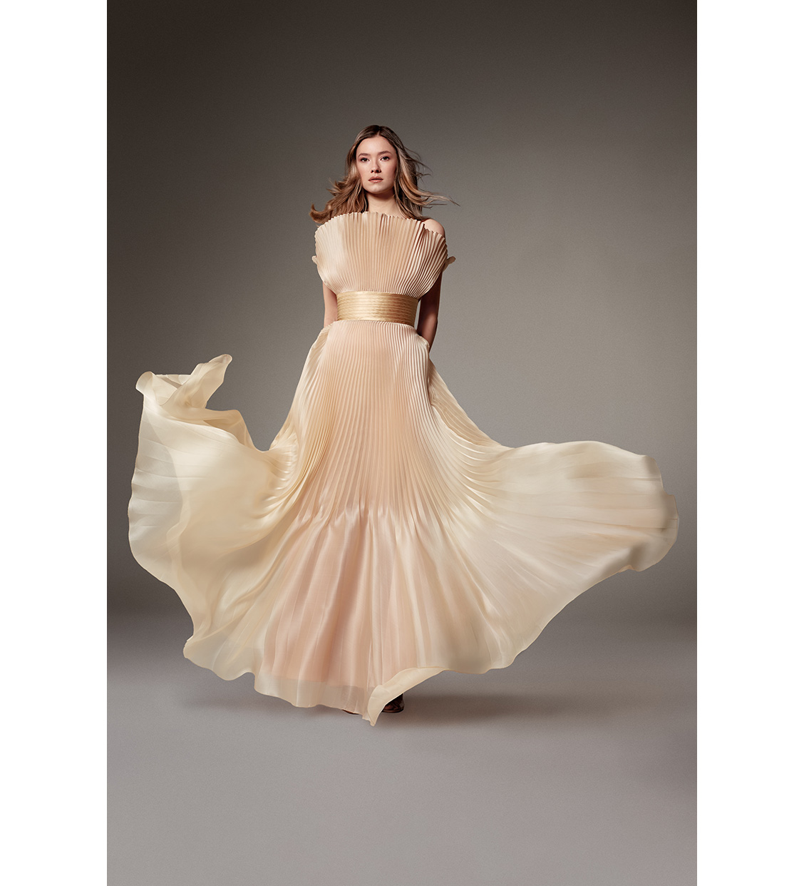 Look 19, Zita d'Hauteville. Long corset gown in sand-colored sunray-pleated satin organza, featuring a fan-shaped neckline and a quilted satin belt. (Photos: Courtesy of Alexis Mabille)