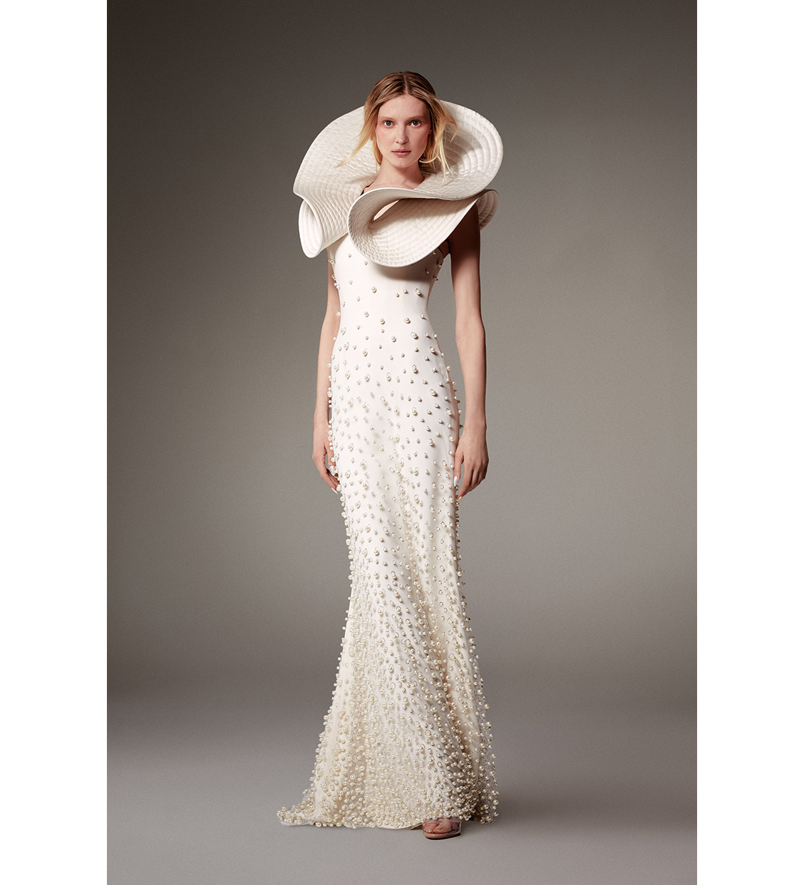 Look 5, Olga Sherer. Long sheath dress, crafted from natural silk-colored crepe and veiled with pearlescent beaded tulle, featuring a matching quilted satin &quot;volutes&quot; collar.
