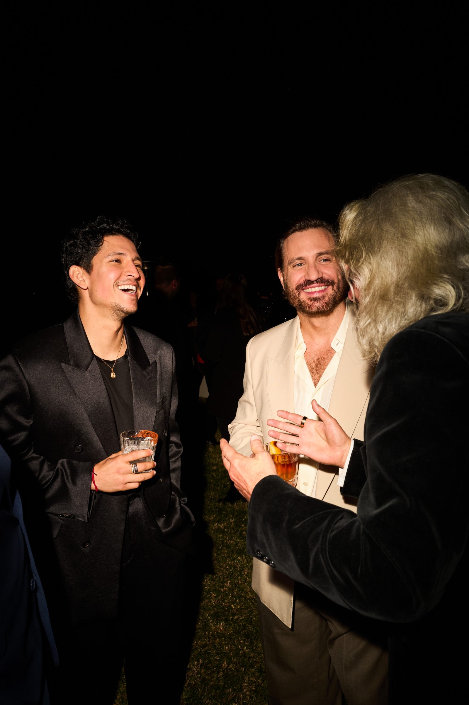 Danny Ramirez and Édgar Ramírez have a laugh at the Saint Laurent x Vanity Fair pre-Oscar dinner in Hollywood Hills. (Photo courtesy of Saint Laurent)